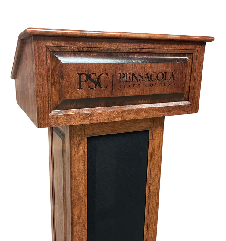 The Counselor Evolution Lift™ lectern, handcrafted from cherry wood, features adjustable height, built-in sound system, and mobility casters.