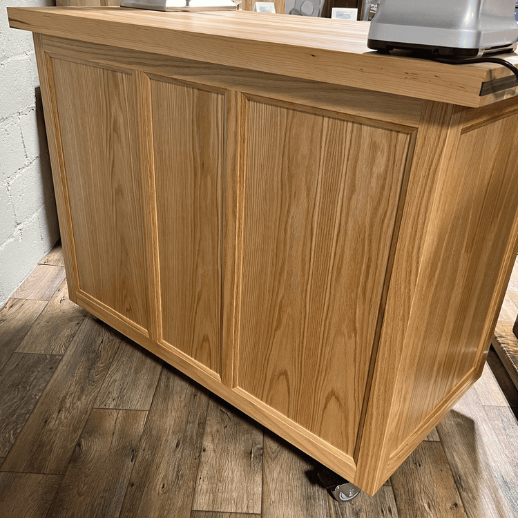 Rolling butcher block island with storage, soft-close drawers, knife holder, and locking wheels for kitchen or outdoor use.