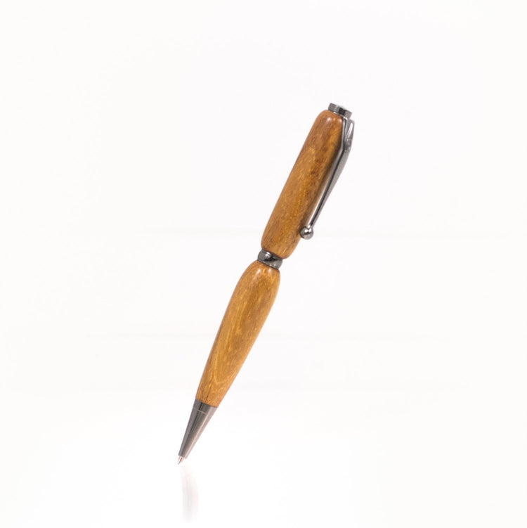 Handcrafted Osage Orange pen with golden-yellow grain, glossy finish, and refillable black ballpoint ink insert, made in Missouri