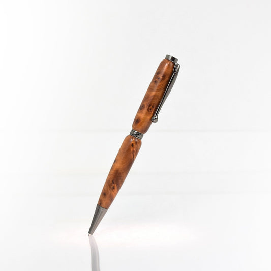Handcrafted Thuya Burl wood pen with golden brown burl grain, glossy finish, and refillable black ballpoint ink insert