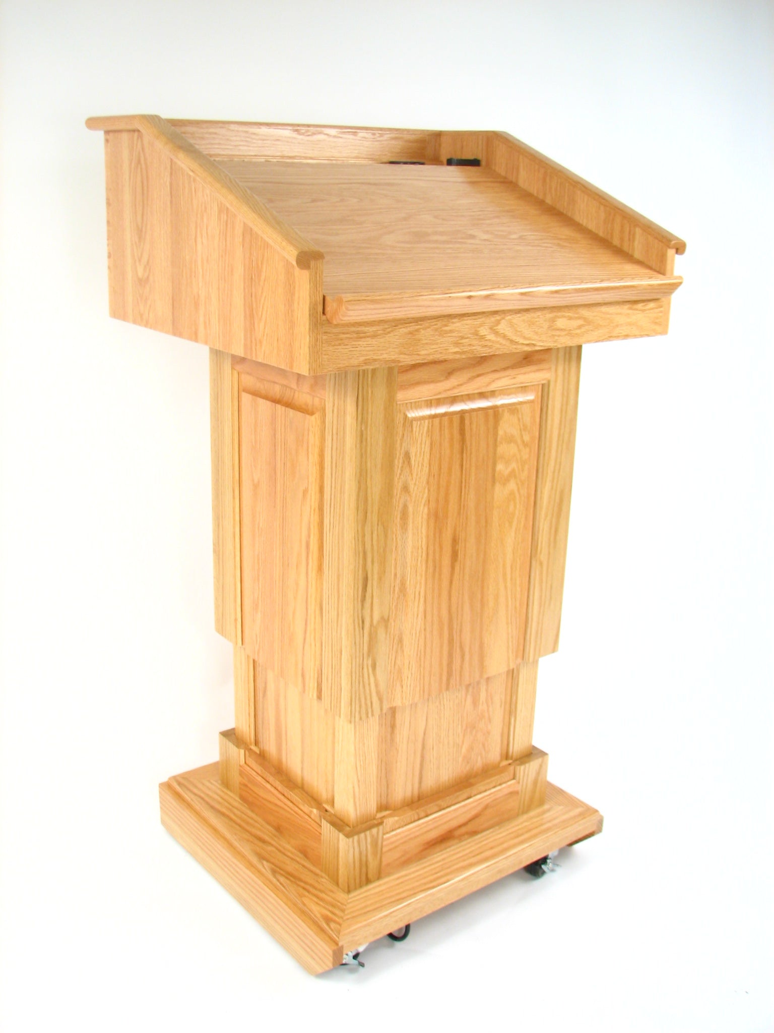 Counselor Lift™ Oak Podium with electric height adjustment, premium hardwood, and mobility casters, ideal for professional settings.