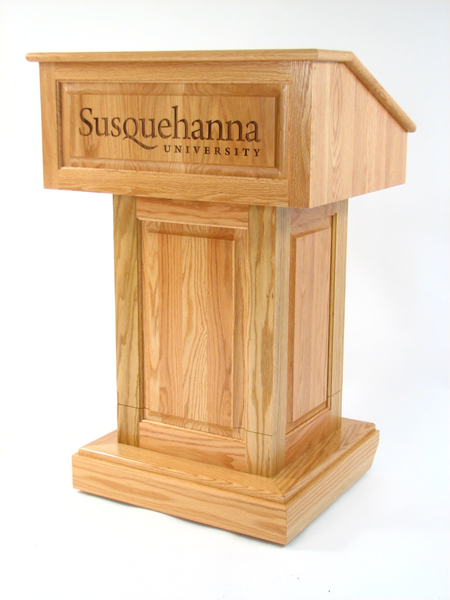 Counselor Lift™ Oak Podium with electric height adjustment, premium hardwood, and mobility casters with an engraving.