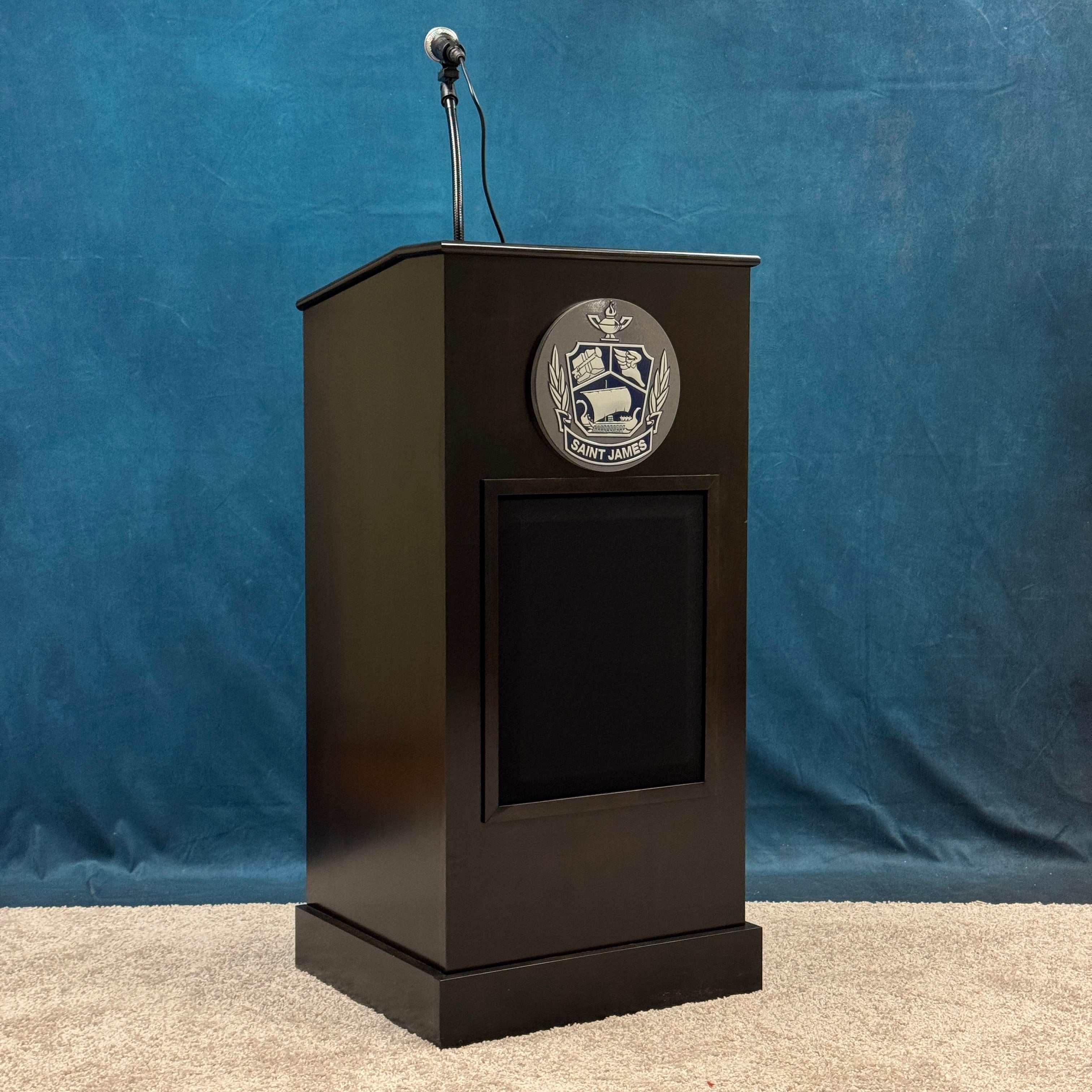 Black podium with a logo on a blue background