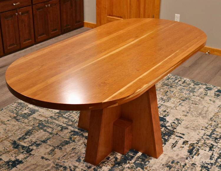 Solid top cherry oval conference table, 72” x 34.5”, handcrafted in the USA for executive offices, boardrooms, and professional spaces.