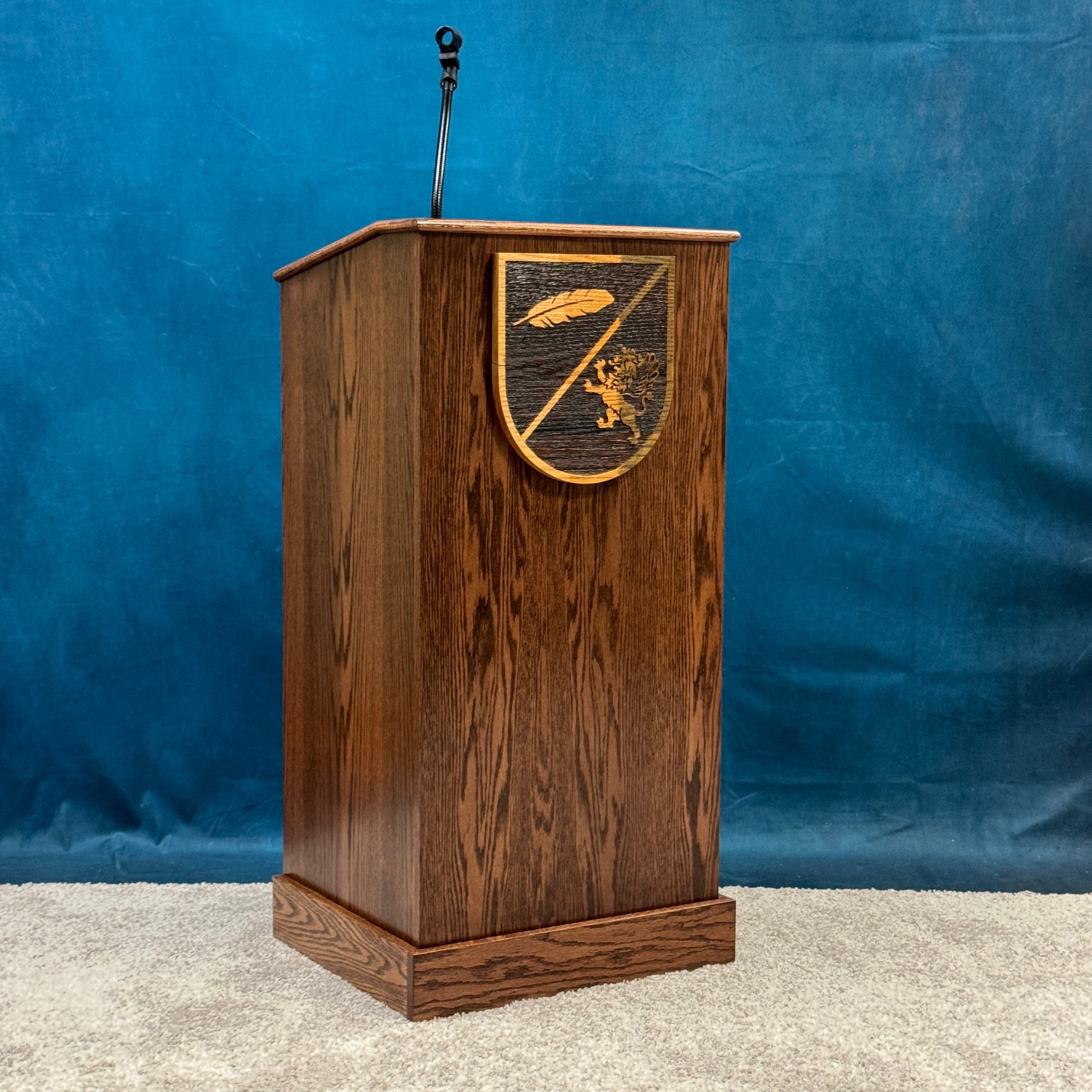Wooden lectern with a decorative emblem on a blue background