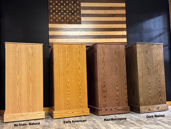Four wooden podiums in different finishes with an American flag in the background.