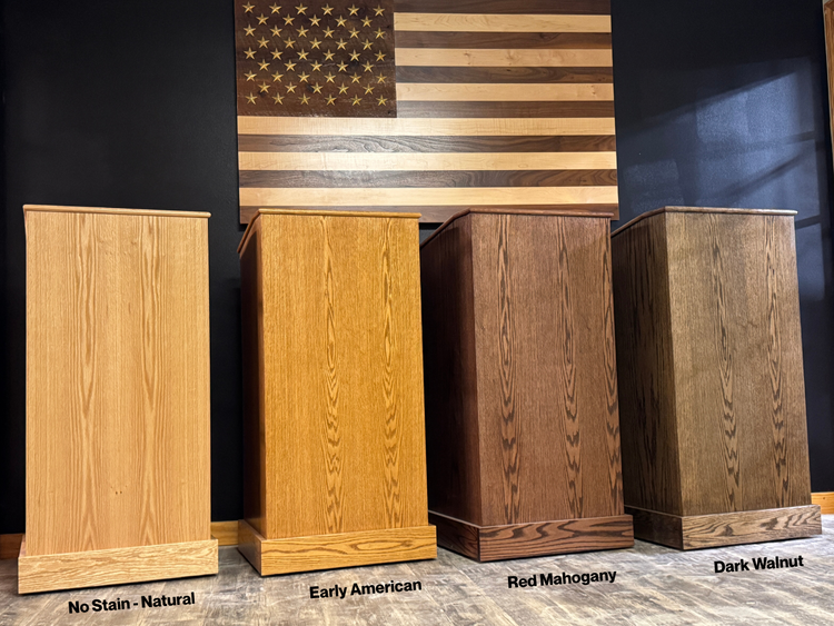 Four wooden podiums in different finishes with an American flag in the background.