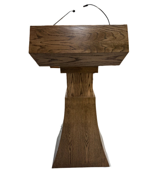 "StatesMan AutoGlide™ Height Adjustable Lift Podium, featuring a smooth, modern design with a sleek lift mechanism, allowing easy adjustment for different speaker heights and creating a versatile and professional presentation space. American made craftsmanship