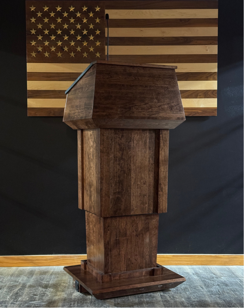 Wooden podium in front of an American flag on a black background