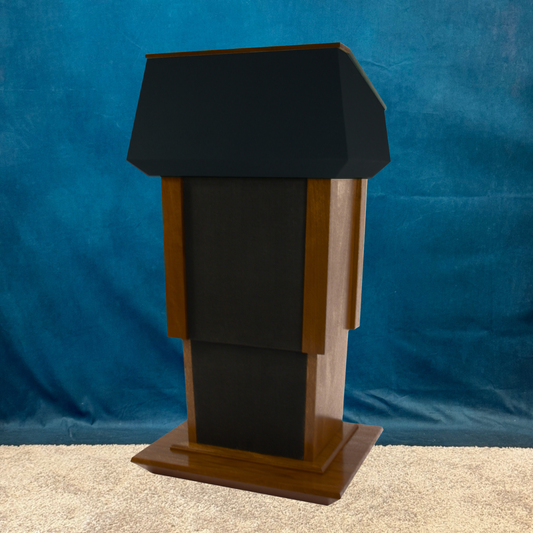 Wooden lectern with black top against a blue curtain background