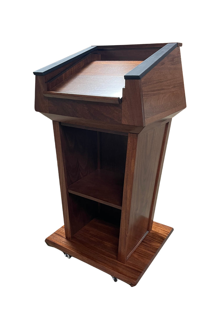 "Presidential™ Solid Hardwood Podium featuring a sleek, classic design with rich wood finish. The podium is crafted from solid hardwood, providing a sturdy and elegant stand for presentations, speeches, and lectures. Ideal for professional settings like conferences, universities, and executive meetings. TEXTILE FABRIC COVERING TOP SEAMLESS AMERICAN MADE HANDCRAFTED LECTERN MOBILE