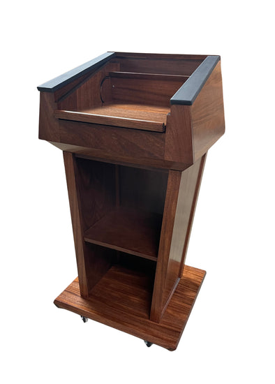 "Presidential™ Solid Hardwood Podium featuring a sleek, classic design with rich wood finish. The podium is crafted from solid hardwood, providing a sturdy and elegant stand for presentations, speeches, and lectures. Ideal for professional settings like conferences, universities, and executive meetings. TEXTILE FABRIC COVERING TOP SEAMLESS AMERICAN MADE HANDCRAFTED LECTERN MOBILE