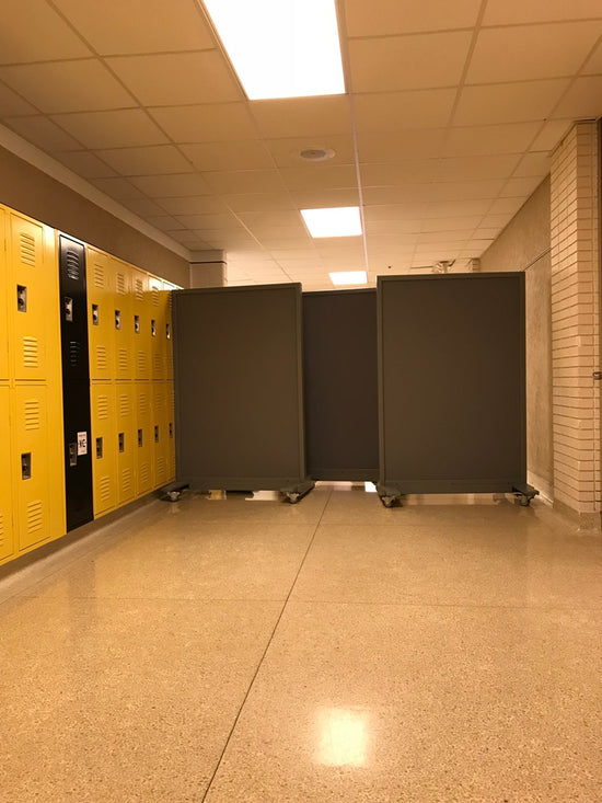 Portable NIJ Level III ballistic panel with a whiteboard, tackable surface, and locking casters for school safety and security.