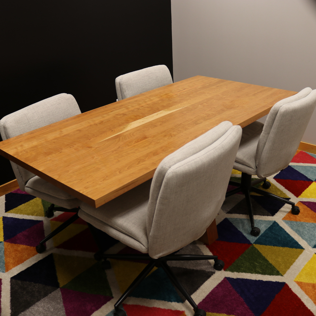 Handcrafted executive office table featuring a luxurious solid cherry wood top. The table showcases a smooth, rich cherry finish with intricate wood grain details, perfect for adding a timeless and professional touch to any office space. american made durable steady