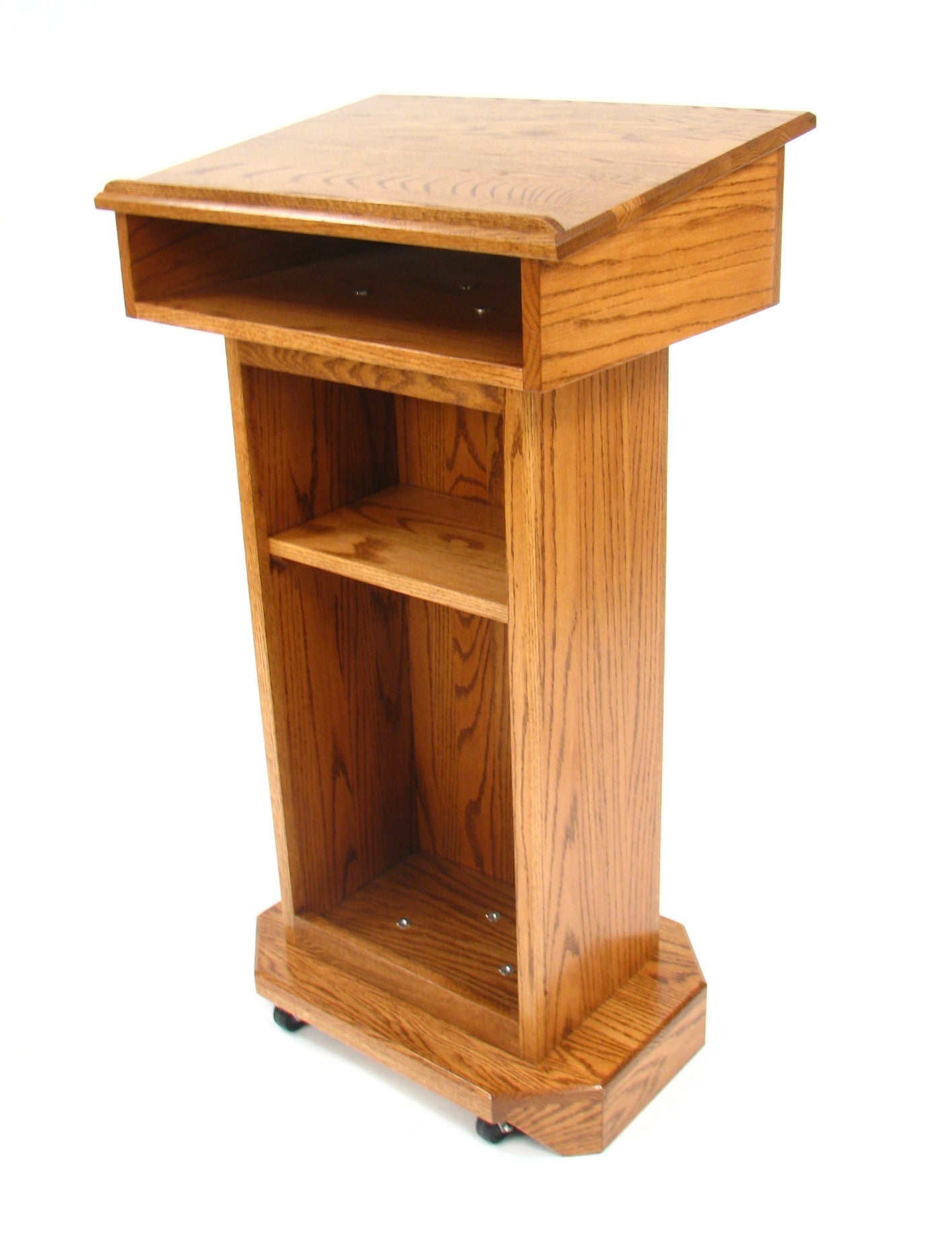  "Senator™ Solid Hardwood Podium, featuring a sleek design made from durable solid wood. It includes a spacious work surface, hidden rear casters for easy mobility, and ample storage space for supplies. Perfect for schools, churches, and event venues." American made craftsmanship Lectern