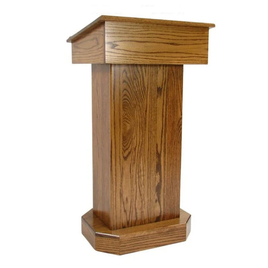  "Senator™ Solid Hardwood Podium, featuring a sleek design made from durable solid wood. It includes a spacious work surface, hidden rear casters for easy mobility, and ample storage space for supplies. Perfect for schools, churches, and event venues." American made craftsmanship Lectern