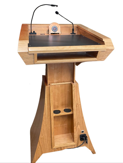 "StatesMan AutoGlide™ Height Adjustable Lift Podium, featuring a smooth, modern design with a sleek lift mechanism, allowing easy adjustment for different speaker heights and creating a versatile and professional presentation space. American made craftsmanship