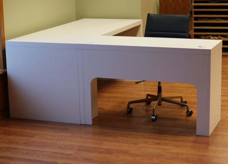 Modern white L-shaped desk of durable maple, with spacious surface, cable grommets, easy assembly for home or office use