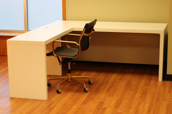 Modern white L-shaped desk of durable maple, with spacious surface, cable grommets, easy assembly for home or office use