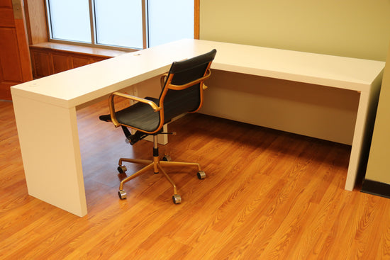 Modern white L-shaped desk of durable maple, with spacious surface, cable grommets, easy assembly for home or office use