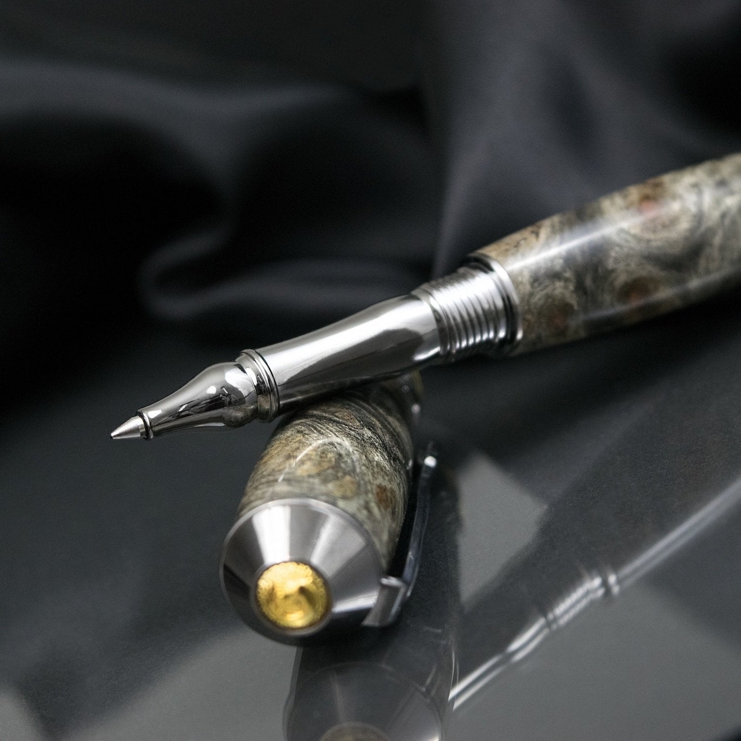Handcrafted Buckeye Burl rollerball pen with precious metal body