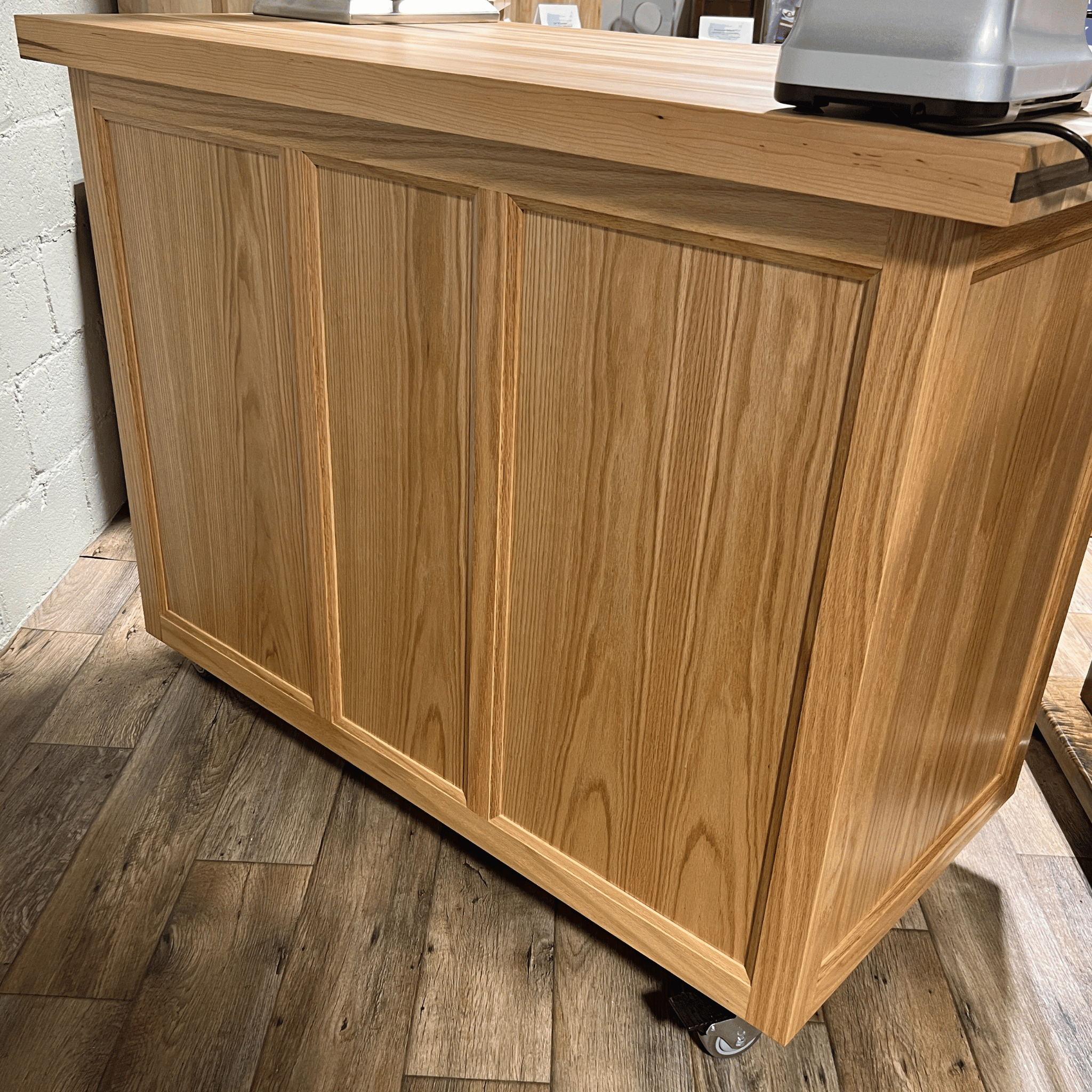 Rolling butcher block island with storage, soft-close drawers, knife holder, and locking wheels for kitchen or outdoor use.