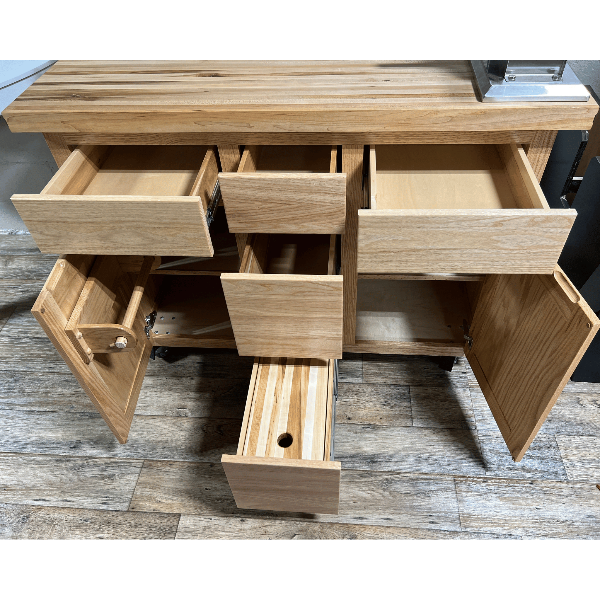 Rolling butcher block island with storage, soft-close drawers, knife holder, and locking wheels for kitchen or outdoor use.