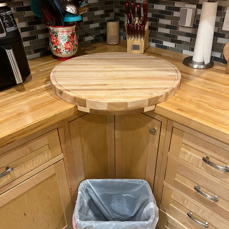 Large round corner cutting board with drip rail, handcrafted from solid maple. Designed for easy cleanup.