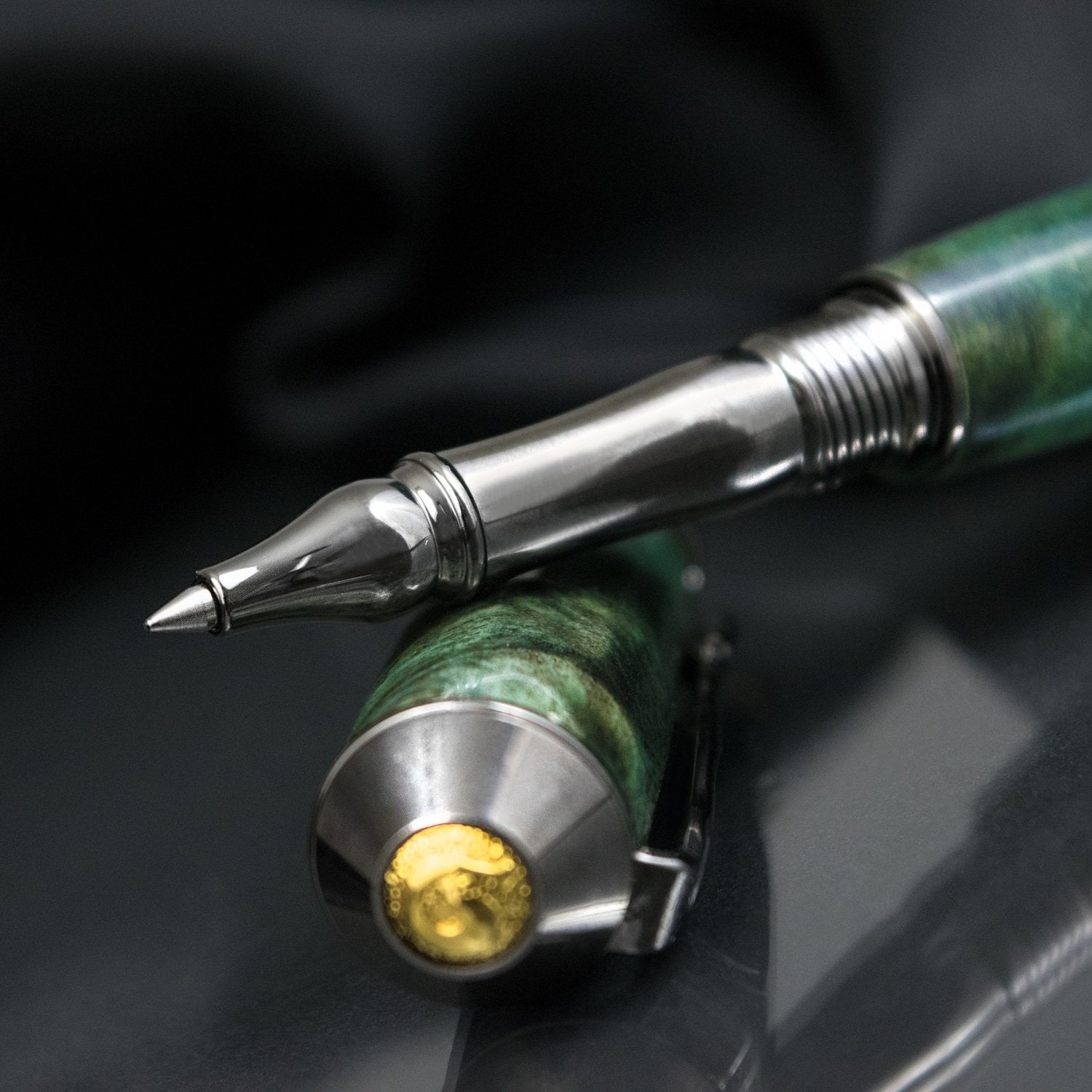 Handcrafted green dyed Buckeye Burl rollerball pen with precious metal body