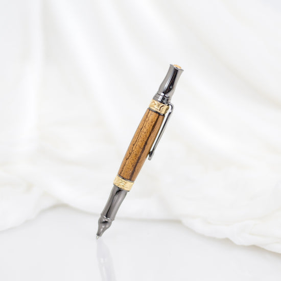 Handcrafted Marblewood rollerball pen with 24K gold accents