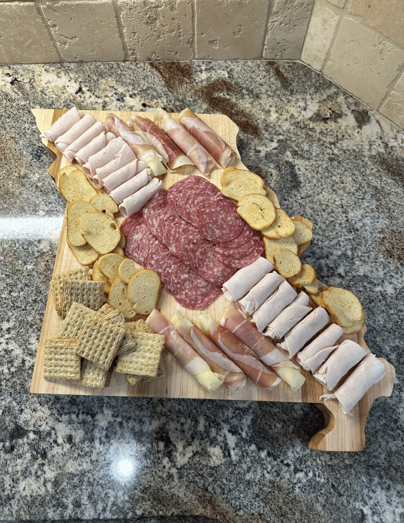 Missouri Handcrafted state-shaped charcuterie board made from solid American hard maple, featuring engraved details and a food-safe finish.