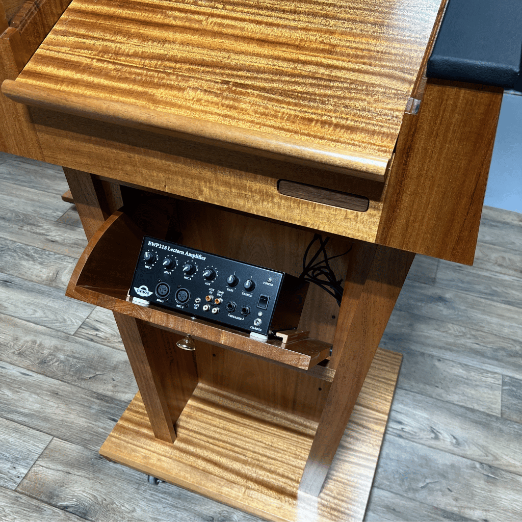 Premium solid wood sound podium with built-in speakers, gooseneck microphone, LED light, magnetic logo system, and pop-out beverage holder.