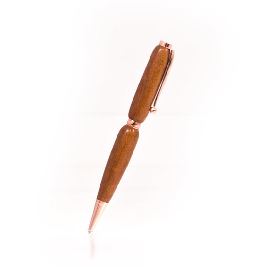Handcrafted Sapele wood pen with reddish-brown grain, glossy finish, and refillable black ballpoint ink insert, made in Missouri