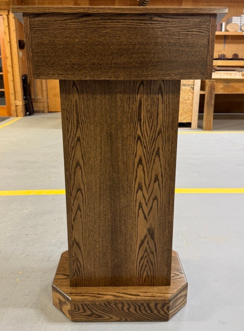 Senator Lectern – Solid red oak podium with storage, hidden casters, and a removable shelf. Handcrafted in the USA.