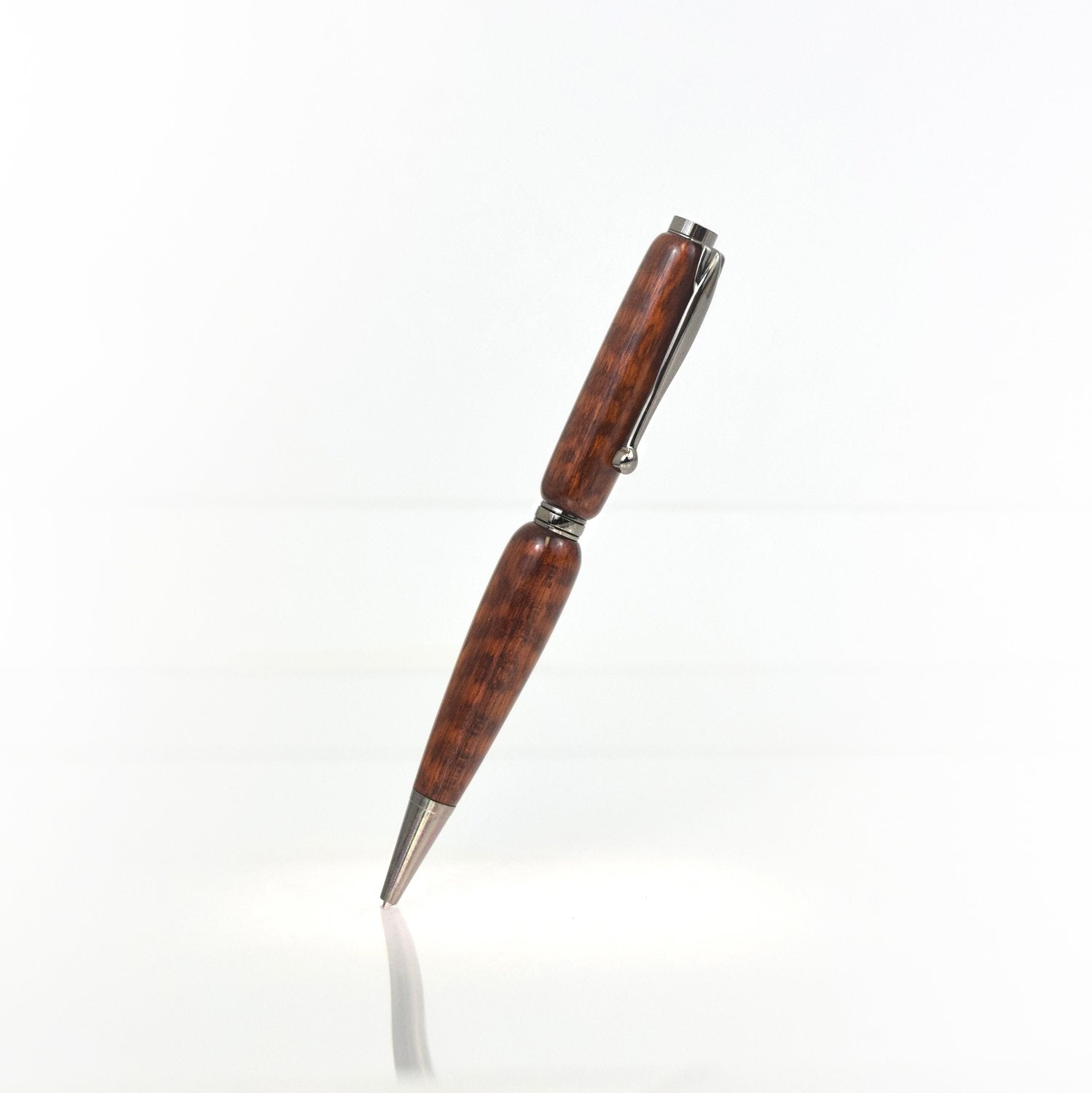 Handcrafted Snakewood pen with scaly grain, glossy finish, and refillable black ballpoint ink insert