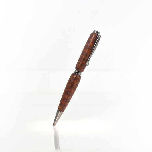 Handcrafted Snakewood pen with scaly grain, glossy finish, and refillable black ballpoint ink insert