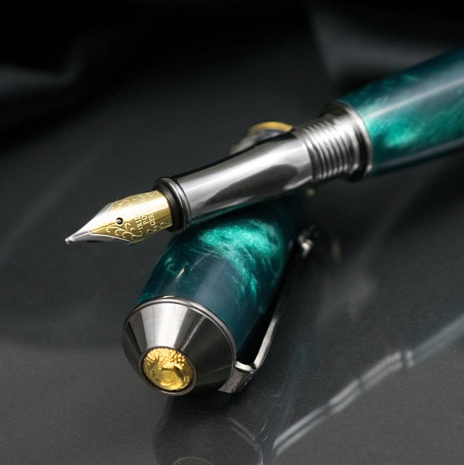 Handcrafted teal acrylic fountain pen with precious metal body