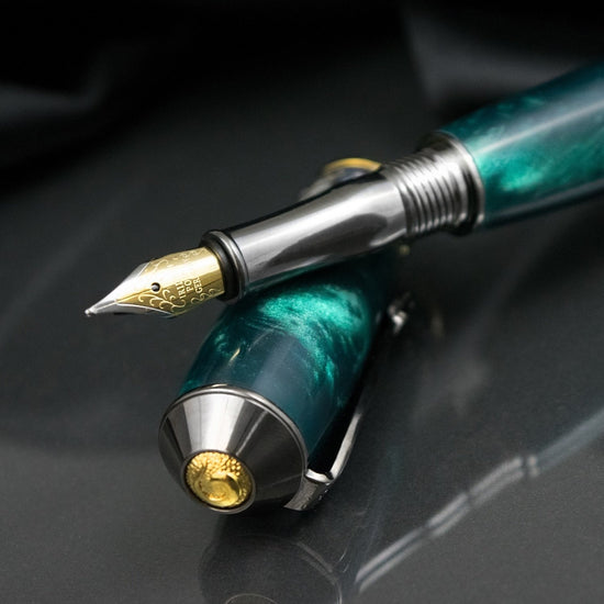 Handcrafted teal acrylic fountain pen with precious metal body