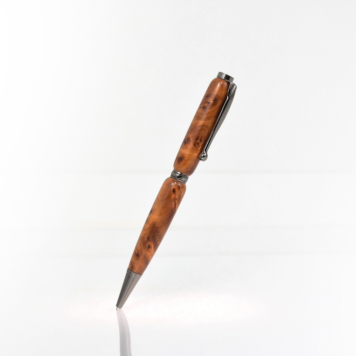 Handcrafted Thuya Burl wood pen with golden brown burl grain, glossy finish, and refillable black ballpoint ink insert