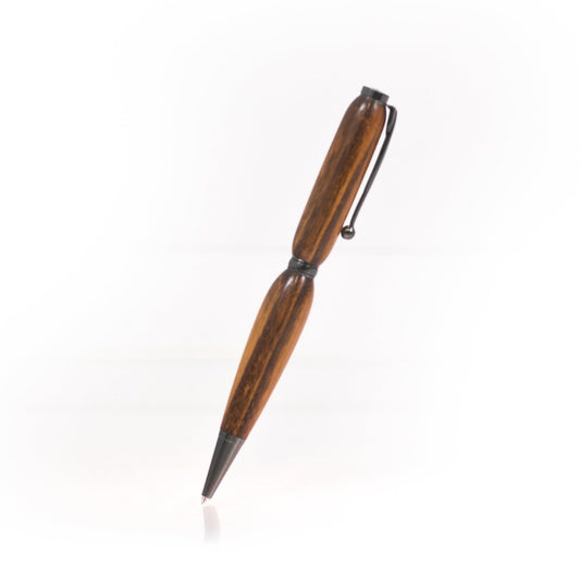 Handcrafted Tigerwood pen with deep reddish tones and dark stripes, glossy finish, refillable black ballpoint insert, made in Missouri