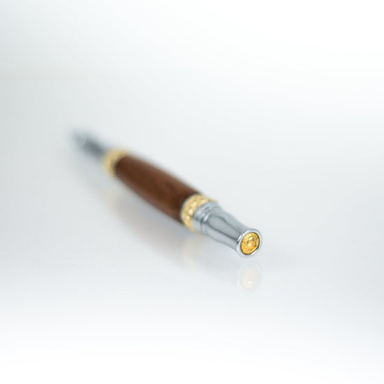Handcrafted walnut rollerball pen with 24K gold accents and metal body