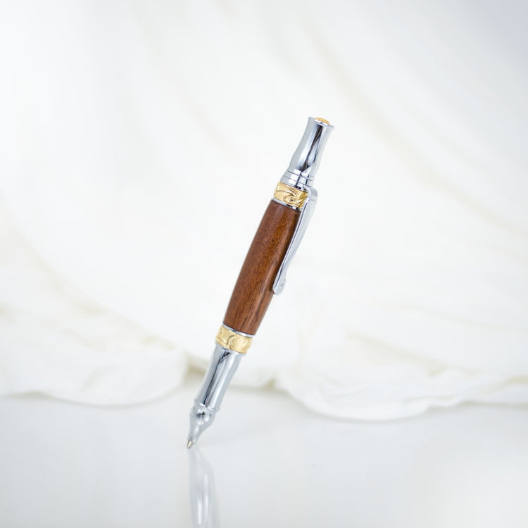 Handcrafted walnut rollerball pen with 24K gold accents and metal body