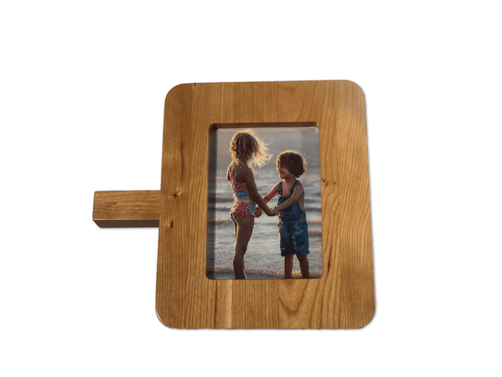 SmartFrame™ wood charging station holds a 5x7 photo, wirelessly charges phones & watches, and amplifies sound. Made in USA.